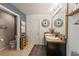 Inviting bathroom featuring double sinks, modern fixtures, a mirror and stylish decor at 10101 Mangrove Well Rd, Ruskin, FL 33573