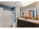 Well-appointed bathroom with double sinks, modern fixtures, a tub, shower and nautical decor at 10101 Mangrove Well Rd, Ruskin, FL 33573