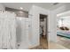 Bathroom with a shower, and a view through the door to the Main Bedroom at 10101 Mangrove Well Rd, Ruskin, FL 33573