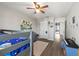 Bright bedroom with bunk beds, a desk, a drum set, and hardwood style floors at 10101 Mangrove Well Rd, Ruskin, FL 33573