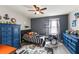 Stylist bedroom with a ceiling fan, desk, a bed, dressers, decor, and a drum set at 10101 Mangrove Well Rd, Ruskin, FL 33573