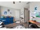 Bright bedroom with a wooden floor, complete with a desk and charming decorations at 10101 Mangrove Well Rd, Ruskin, FL 33573