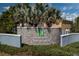 Elegant stone community sign for The Orchids at Cypress Creek, framed by lush landscaping at 10101 Mangrove Well Rd, Ruskin, FL 33573