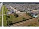 Aerial view of a community dog park with fenced areas, trees, and benches at 10101 Mangrove Well Rd, Ruskin, FL 33573