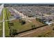 Aerial view of a community dog park with fenced areas and trees at 10101 Mangrove Well Rd, Ruskin, FL 33573