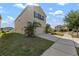 Two-story home with an attached garage, showcasing the driveway and landscaping at 10101 Mangrove Well Rd, Ruskin, FL 33573