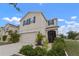 Two story home with neutral paint, dark shutters, landscaping and a two car garage at 10101 Mangrove Well Rd, Ruskin, FL 33573
