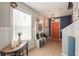 Inviting foyer with an orange door, tiled floor, and a hall tree with bench at 10101 Mangrove Well Rd, Ruskin, FL 33573