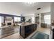 Modern kitchen with an island sink, lots of cabinets, and open access to the living area at 10101 Mangrove Well Rd, Ruskin, FL 33573
