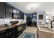 Modern kitchen featuring stainless steel appliances, sleek black cabinetry and tiled backsplash at 10101 Mangrove Well Rd, Ruskin, FL 33573