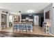 Kitchen island with barstool seating connecting to a modern kitchen and dining area at 10101 Mangrove Well Rd, Ruskin, FL 33573
