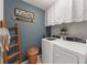 Convenient laundry room equipped with modern washer, dryer, decor and ample space at 10101 Mangrove Well Rd, Ruskin, FL 33573