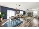 Inviting living room with fireplace, dark accent wall, and an adjoining dining area at 10101 Mangrove Well Rd, Ruskin, FL 33573