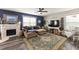 Relaxing living room with an electric fireplace, a beige sectional, and stylish decor at 10101 Mangrove Well Rd, Ruskin, FL 33573