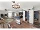 Spacious living room showing the layout with open flow to the kitchen and a sliding barn door at 10101 Mangrove Well Rd, Ruskin, FL 33573