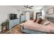 Comfortable main bedroom showcasing a stylish bed, nice dresser, decor, and a barn door at 10101 Mangrove Well Rd, Ruskin, FL 33573