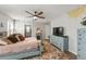 Spacious main bedroom featuring an elegant ceiling fan, a fireplace, and a cozy decor with a TV at 10101 Mangrove Well Rd, Ruskin, FL 33573