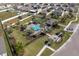 Aerial view of a refreshing community pool with inviting blue waters and tropical palms at 10101 Mangrove Well Rd, Ruskin, FL 33573
