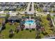 Community pool surrounded by lush landscaping with lounge seating and shade at 10101 Mangrove Well Rd, Ruskin, FL 33573