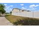 Suburban street view with sidewalks, featuring a view of the home and surrounding landscaping at 10101 Mangrove Well Rd, Ruskin, FL 33573