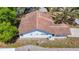 An elevated aerial view highlights the roof and back of the home, emphasizing the yard, windows, and architectural details at 10819 Los Santos Dr, Port Richey, FL 34668