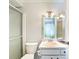 Traditional bathroom with a shower and a peach colored sink and countertop at 10819 Los Santos Dr, Port Richey, FL 34668