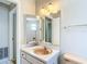 Traditional bathroom with a vanity with a peach sink and a large mirror at 10819 Los Santos Dr, Port Richey, FL 34668