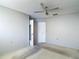 Spacious bedroom with a ceiling fan and a large closet, offering ample storage at 10819 Los Santos Dr, Port Richey, FL 34668
