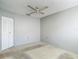 Bedroom with a closet featuring sliding doors, carpeted floors and a ceiling fan at 10819 Los Santos Dr, Port Richey, FL 34668