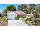 A charming single-Gathering home with a one-car garage, front porch, and well-maintained front lawn are captured in this image at 10819 Los Santos Dr, Port Richey, FL 34668
