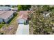 An exterior aerial shot reveals a quaint single-Gathering home with a driveway, garage, and mature tree in the front yard at 10819 Los Santos Dr, Port Richey, FL 34668