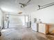 This is an image of a garage that includes a utility sink, laundry units, shelves, water heater, and a workbench at 10819 Los Santos Dr, Port Richey, FL 34668