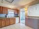 Classic kitchen design featuring wood cabinets, white appliances, and tile floors at 10819 Los Santos Dr, Port Richey, FL 34668