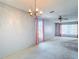 Open living room with carpet and chandelier at 10819 Los Santos Dr, Port Richey, FL 34668
