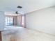 Large living room featuring carpet, ceiling fan, and lots of natural light at 10819 Los Santos Dr, Port Richey, FL 34668