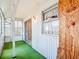Cozy sunroom with a green floor and large windows, perfect for relaxation at 10819 Los Santos Dr, Port Richey, FL 34668