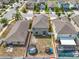 Aerial view of the property featuring a fenced backyard with playset, trampoline, and screened pool at 14812 Boulder Pass Pl, Wimauma, FL 33598