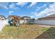 Fenced backyard featuring a playset with slides, swing, and trampoline at 14812 Boulder Pass Pl, Wimauma, FL 33598