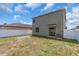 Fenced backyard with green grass and newly installed patio at 14812 Boulder Pass Pl, Wimauma, FL 33598