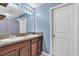 Bathroom featuring double sinks, granite countertops, and updated lighting at 14812 Boulder Pass Pl, Wimauma, FL 33598