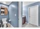 Full bathroom showcasing stylish blue walls and tile floors at 14812 Boulder Pass Pl, Wimauma, FL 33598