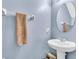 Powder room with pedestal sink, oval mirror, and stylish towel rack at 14812 Boulder Pass Pl, Wimauma, FL 33598