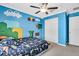 Bedroom features blue walls with gaming-themed decor at 14812 Boulder Pass Pl, Wimauma, FL 33598