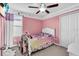 Cute bedroom with pink walls, white trim, and natural light at 14812 Boulder Pass Pl, Wimauma, FL 33598