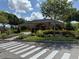 A beautifully landscaped community clubhouse with brick accents, mature landscaping and ample parking at 14812 Boulder Pass Pl, Wimauma, FL 33598