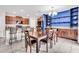 Bright dining area with table, six chairs, and blue accent wall with built-in shelving at 14812 Boulder Pass Pl, Wimauma, FL 33598