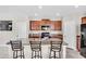 Spacious kitchen featuring an island with bar seating, modern appliances and a pantry at 14812 Boulder Pass Pl, Wimauma, FL 33598