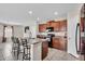 Modern kitchen with granite countertops, stainless steel appliances, and a breakfast bar at 14812 Boulder Pass Pl, Wimauma, FL 33598