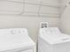 This laundry room features a side-by-side washer and dryer at 14812 Boulder Pass Pl, Wimauma, FL 33598