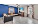 Open living room features tile floors, mounted TV, and comfortable seating at 14812 Boulder Pass Pl, Wimauma, FL 33598